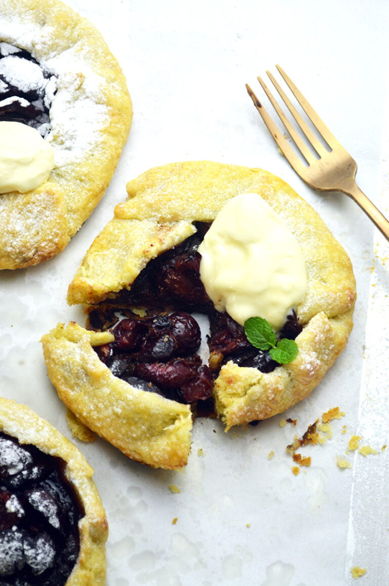 cherry galettes with whipped cream and mint leaves