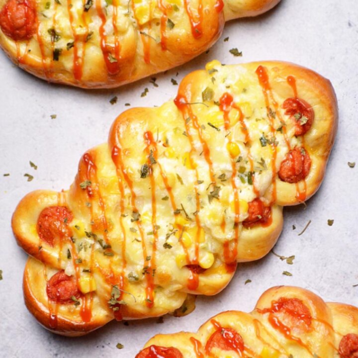 korean sausage bread with corn onion cheese topping and ketchup drizzle