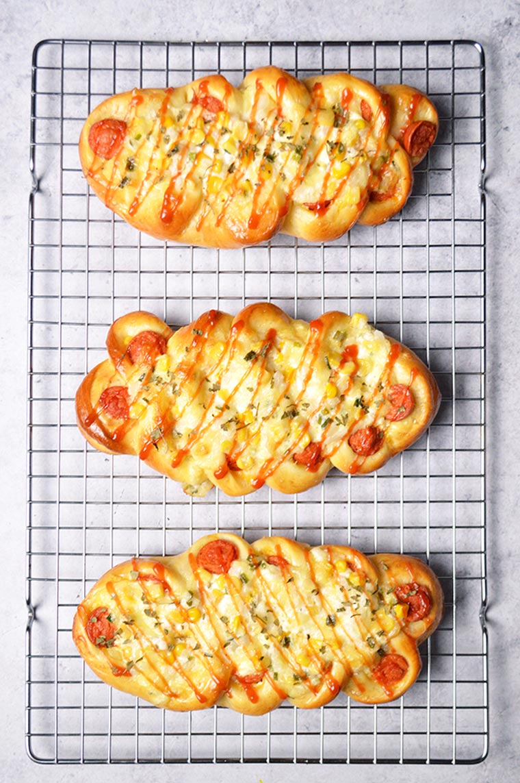 korean sausage bread with corn onion cheese topping and ketchup drizzle