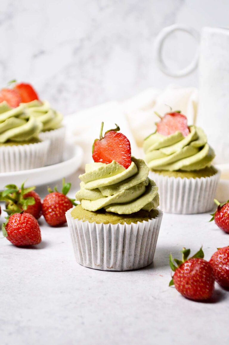 matcha cupcakes with matcha white chocolate ganache frosting and half fresh strawberry